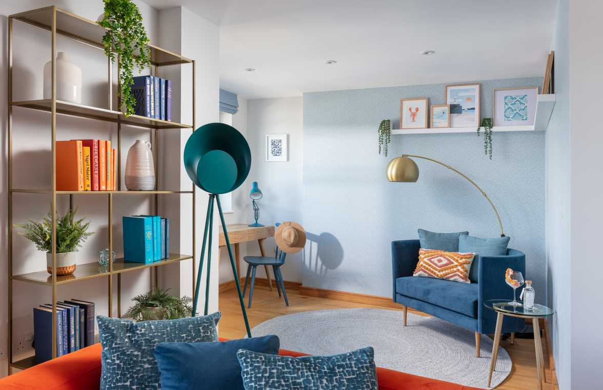 blue sofa inside lounge with lamp